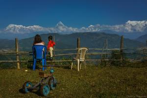a woman and a child looking at the mountains at Mountain View Eco Farm in Rānīpauwa