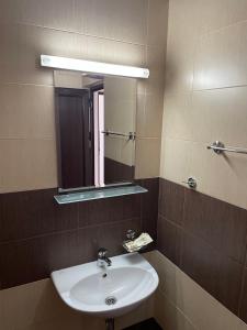 a bathroom with a sink and a mirror at KTB Manastira Holiday Village in Oreshak