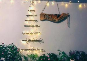 a christmas tree made out of skis on a wall at NHỚ House I in Da Lat