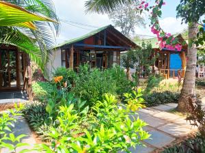 a house with a garden in front of it at Peace Garden Beach Resort in Canacona