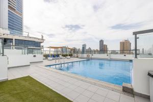 a large swimming pool on the roof of a building at Unique Cosy &Spacious 2BR In Al Sufouh in Dubai