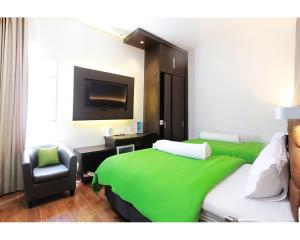 Postel nebo postele na pokoji v ubytování Emerald Hotel