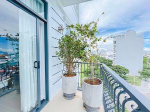 - un balcon avec deux plantes en pot dans l'établissement Lam's Beach Homestay, à Phan Thiết