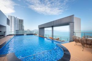 a swimming pool on the roof of a building at Asteria Comodo Nha Trang Hotel in Nha Trang