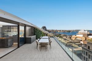 a balcony with a table and chairs on a building at HARR85TR - Harrington on the Harbour in Sydney