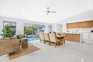 a kitchen and living room with a table and chairs at Chic Miami 4BR Retreat with Swimming Pool & BBQ in Gold Coast