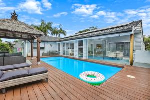 a house with a swimming pool and a deck at Chic Miami 4BR Retreat with Swimming Pool & BBQ in Gold Coast