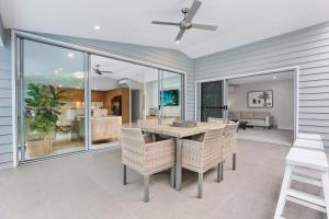 a dining room with a table and chairs at Chic Miami 4BR Retreat with Swimming Pool & BBQ in Gold Coast