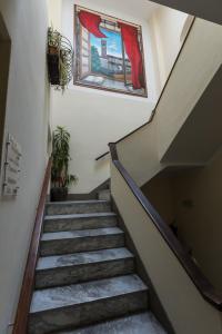 a staircase in a house with a painting on the wall at Locanda dei Fiori in Pistoia