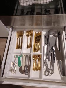 a drawer filled with lots of kitchen utensils at CITYLIFE Apartments Economy Osnabrück in Osnabrück