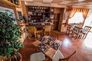 a restaurant with tables and chairs and a bar at Penzion U Tulaka in Dobřichovice
