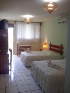 Ένα ή περισσότερα κρεβάτια σε δωμάτιο στο Nakum Hotel