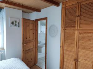 a bathroom with a toilet and a wooden door at Ferienwohnung "Günni" in Nübbel