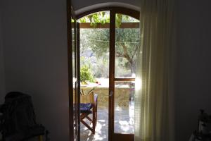 an open door with a view of a yard at Porto Heli Apartments in Palekastron