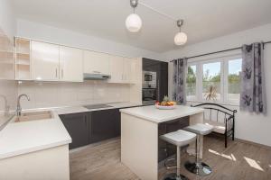 a kitchen with white cabinets and a white counter top at Villa Valentina Nin in Ninski Stanovi