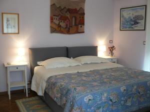 a bedroom with a bed with two tables and two lamps at Casa VELARDI in Viagrande
