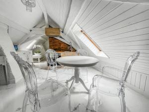 a dining room with a table and chairs in a attic at Loft apartment in the Castle Château du Châtelard in Montreux