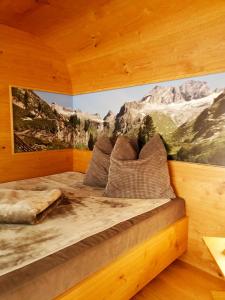 a bedroom with a bed with a painting on the wall at Appartement Schneekristall in Fendels