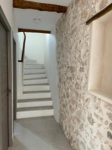 a staircase in a house with a stone wall at Rue Guillaumont heart of old Antibes in Antibes