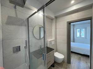 a bathroom with a shower with a sink and a toilet at Rue Guillaumont heart of old Antibes in Antibes