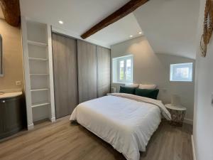 a bedroom with a large white bed and a sink at Rue Guillaumont heart of old Antibes in Antibes
