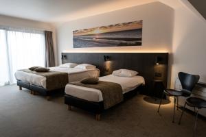 Postel nebo postele na pokoji v ubytování Hotel Apostroff