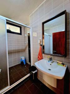 a bathroom with a sink and a shower with a mirror at F4 résidence hasnaoui in Oran