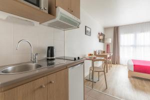 a kitchen with a sink and a counter top at Appart'City Classic Lyon Part Dieu Villette in Lyon