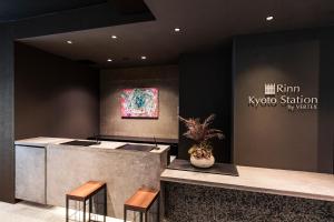 a lobby of a k pop station with a potted plant at Rinn Kyoto Station in Kyoto