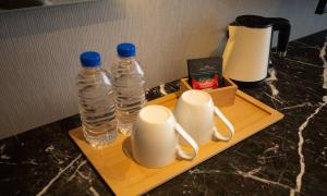 two bottles of water sitting on a tray on a counter at Jeonju Tourist Hotel kkotsim in Jeonju