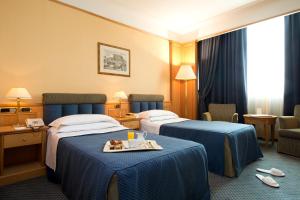 Postel nebo postele na pokoji v ubytování Grand Hotel Barone Di Sassj