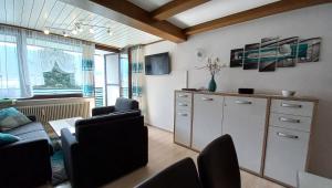 a living room with a couch and a table and chairs at DANIELA Seeblick Appartement Haus Hänsel Gretel am Ossiacher See, Hallenbad, Skiarena Gerlitzen in Stiegl