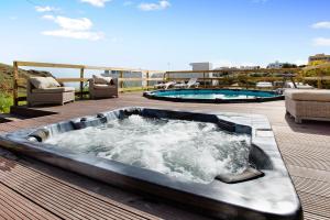 a hot tub on a deck with two pools at Montemar 2 in Moya