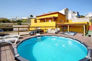 a swimming pool on a deck with a house at Montemar 2 in Moya