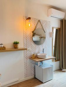 a bathroom with a sink and a mirror at La Bartola Guesthouse in Ibiza Town
