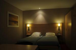 Postel nebo postele na pokoji v ubytování Hotel Escapade