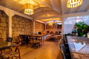 a room with tables and chairs and a couch at 777 Alaçatı Adults only in Alacati