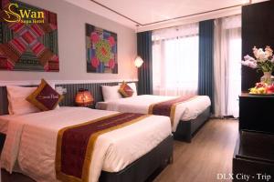 Postel nebo postele na pokoji v ubytování Swan Sapa Hotel