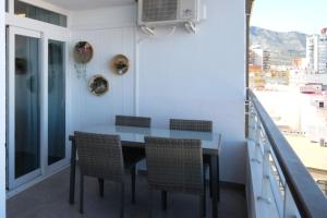 a dining room with a table and chairs on a balcony at Apartamentos la Nogalera in Torremolinos