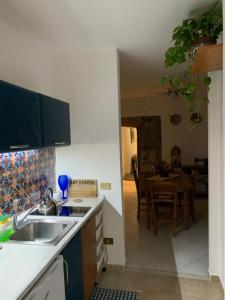 a kitchen with a sink and a kitchen with a table at La Giara in Palermo +24 photos