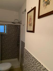 a bathroom with a shower and a toilet and a sink at La Giara in Palermo