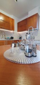 a kitchen counter with a tray of dishes on it at Bay View Villas Nina 12c in Kosharitsa