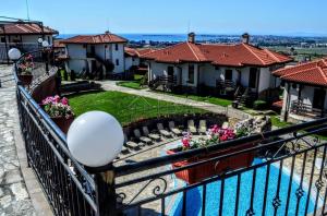 a balcony of a house with a pool and houses at Bay View Villas Nina 12c in Kosharitsa