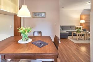 a dining room with a table and a living room at Strandresidenz Timmendorfer Strand Apartment 215 in Timmendorfer Strand