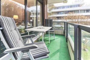 a balcony with a table and chairs on a balcony at Strandresidenz Timmendorfer Strand Apartment 215 in Timmendorfer Strand