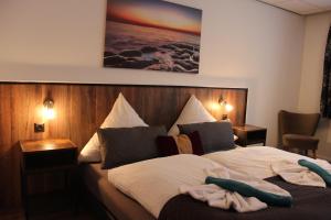 a bedroom with a bed with two towels on it at Waldpension Pfeiferhaus in Warmensteinach