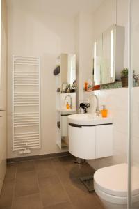 a white bathroom with a toilet and a sink at Ferienwohnung Teldec in Nortorf