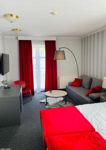 a hotel room with a bed and a couch at Hotel Lival in Gdańsk
