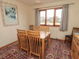 a dining room with a wooden table and chairs at Causeway Cottage in Berwick-Upon-Tweed