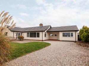 a house with a gravel driveway in front of it at Coedfan in Ruthin